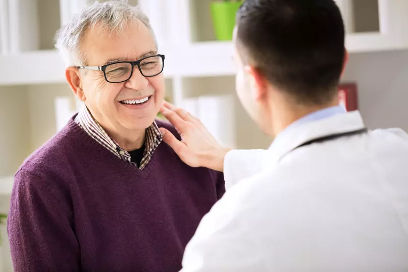 Smiling man visits doctor