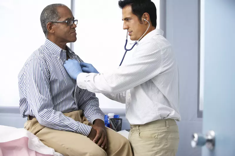 A doctor uses a stethoscope to listen to a patient's healthy heart.