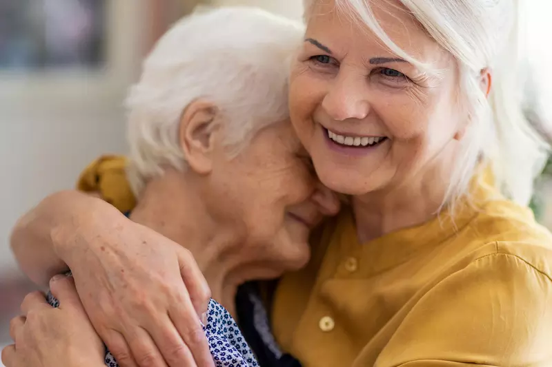 Senior Woman Embracing Older Woman