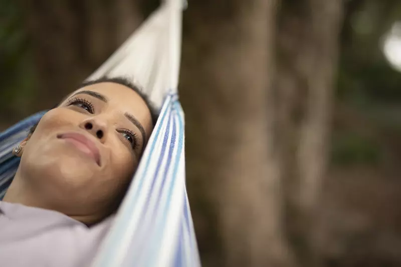 Woman relaxing in hammock outdoors