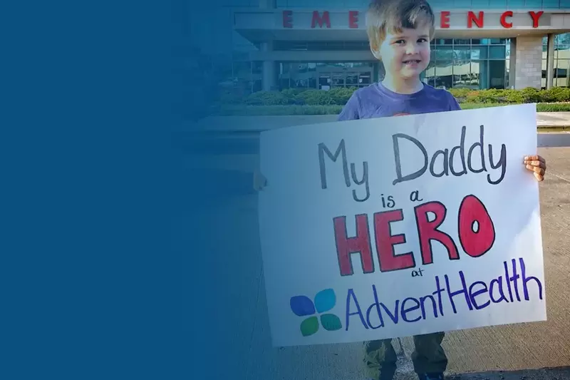 child holding sign outside hospital, AdventHealth Foundation COVID-19