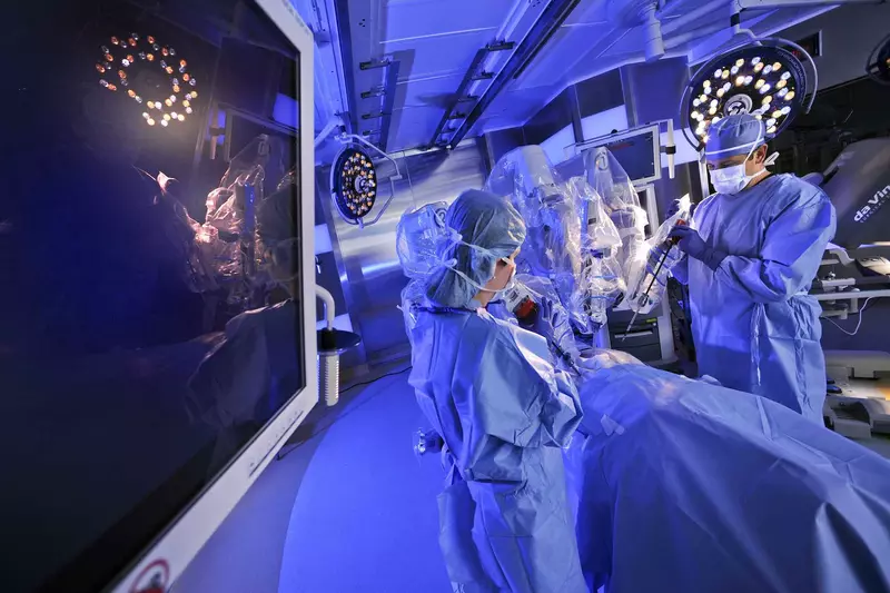 A physician and his staff are scrubbed-in in an operating room, preparing to perform a high-tech procedure at AdventHealth.