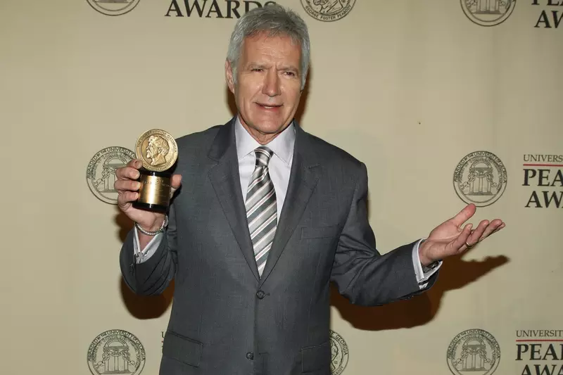 Alex Trebek getting a picture taken with the Peabody Award