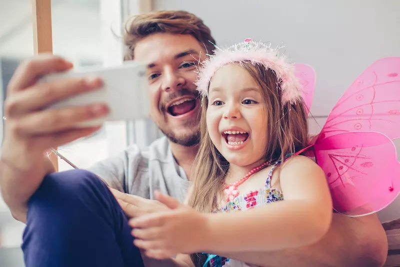 A father and daughter stay connected with a video call.