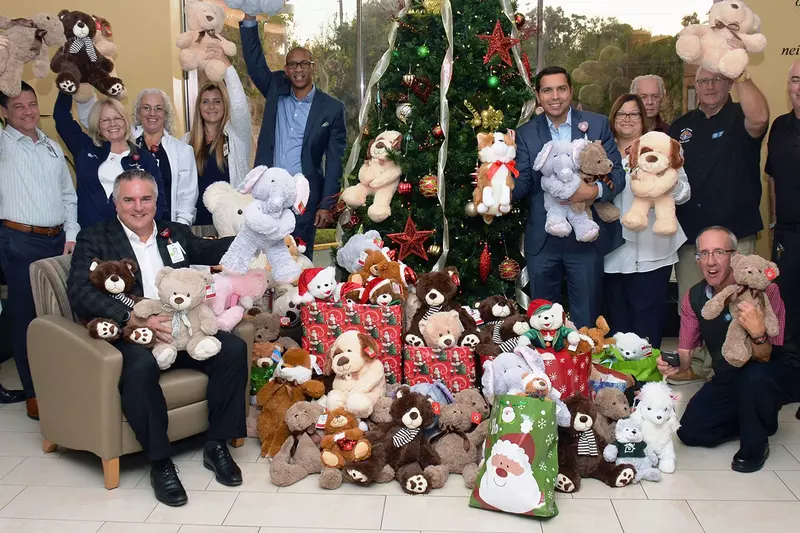 AdventHealth employees and doctors holding up teddy bear donations