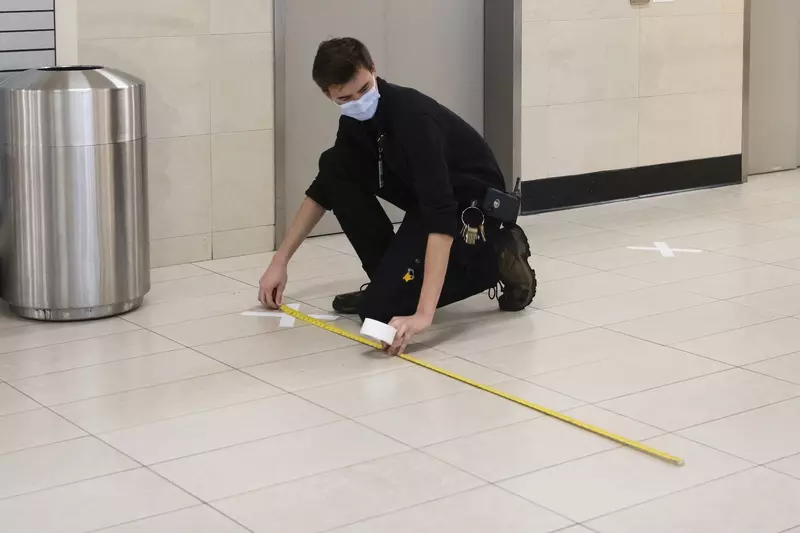 An AdventHealth employee measuring 6 feet for social distancing.