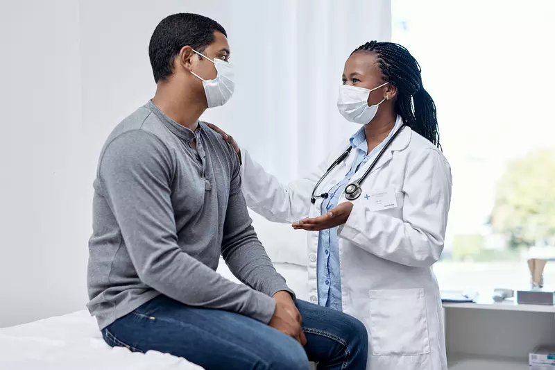 A physician discussing something to her patient