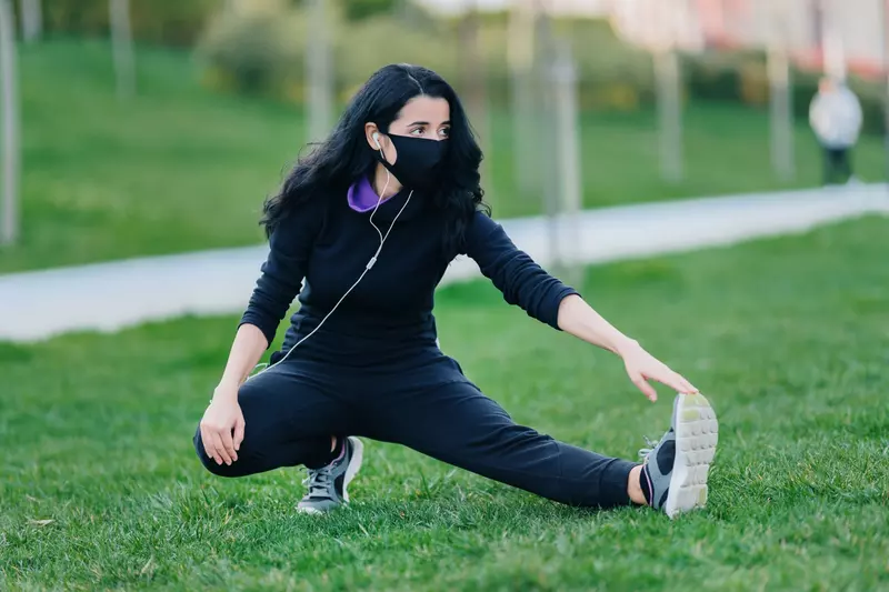 A woman stretching before she exercises