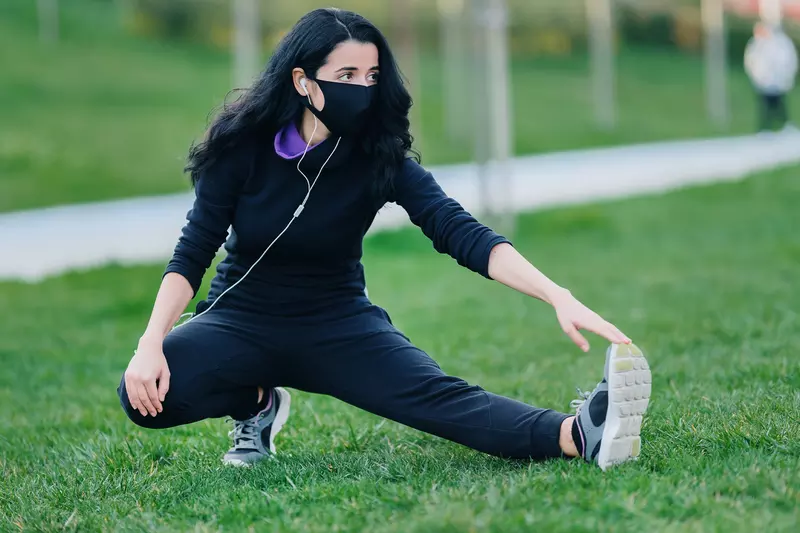 A woman stretching outdoors.