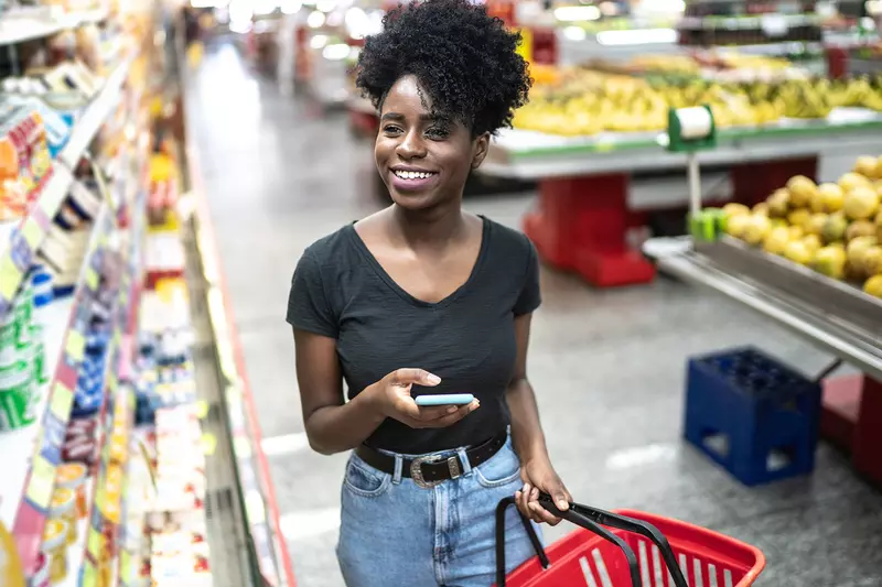 A young woman shops at the grocery store