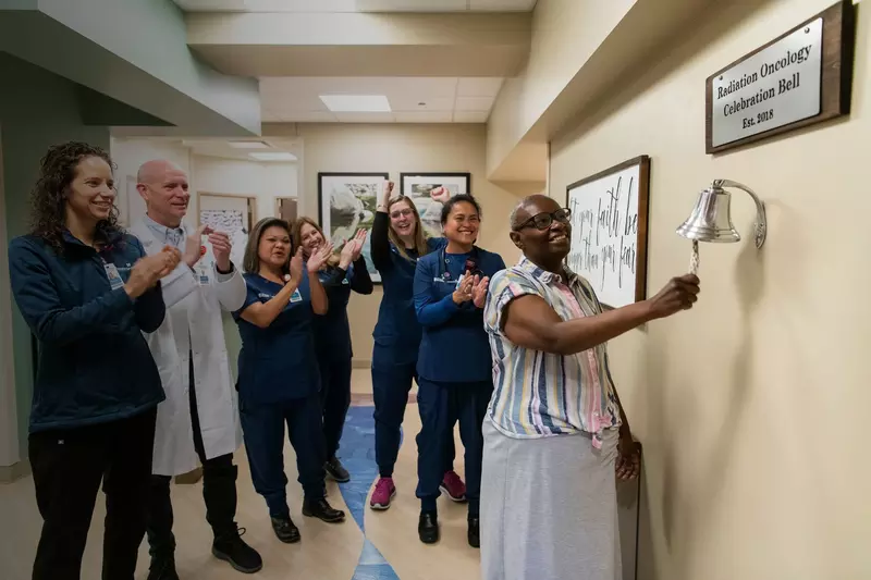 A cancer survivor ringing a bell