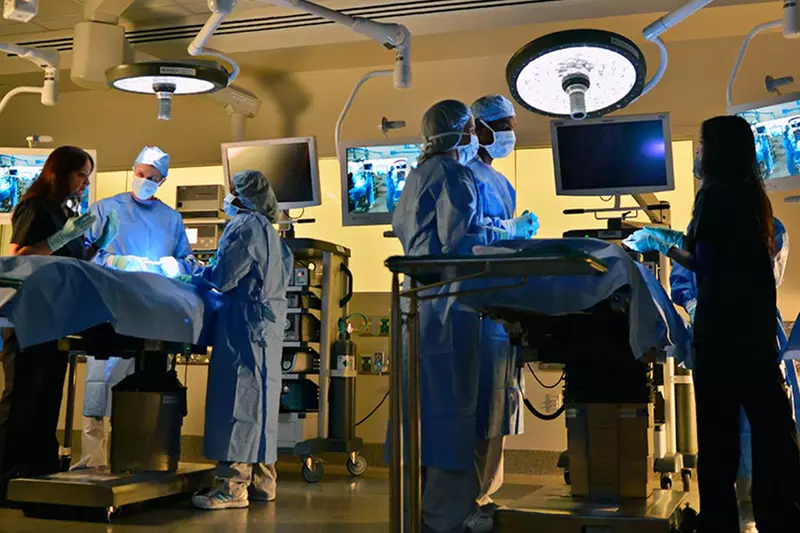 Surgeons around operating tables at the Nicholson Center.