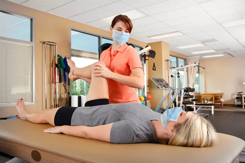 A woman getting physical therapy done by a female specialist