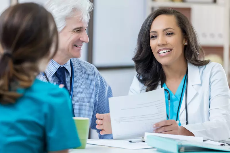 Two physicians interviewing job candidate