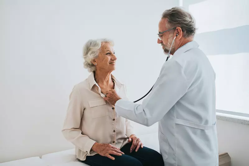 Older woman getting her heartbeat checked by a doctor.