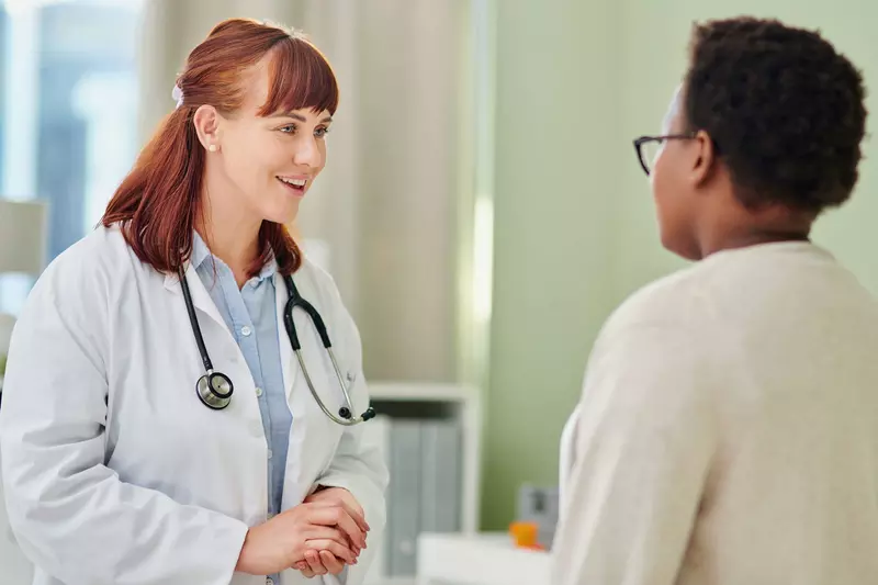 Female doctor talks with female patient