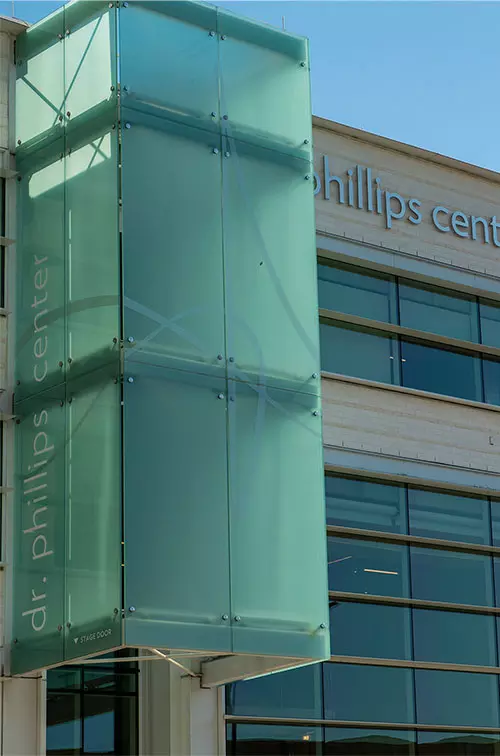 Facade of the Dr. Phillips Center for the Performing Arts with the AdventHealth School of Arts signage.