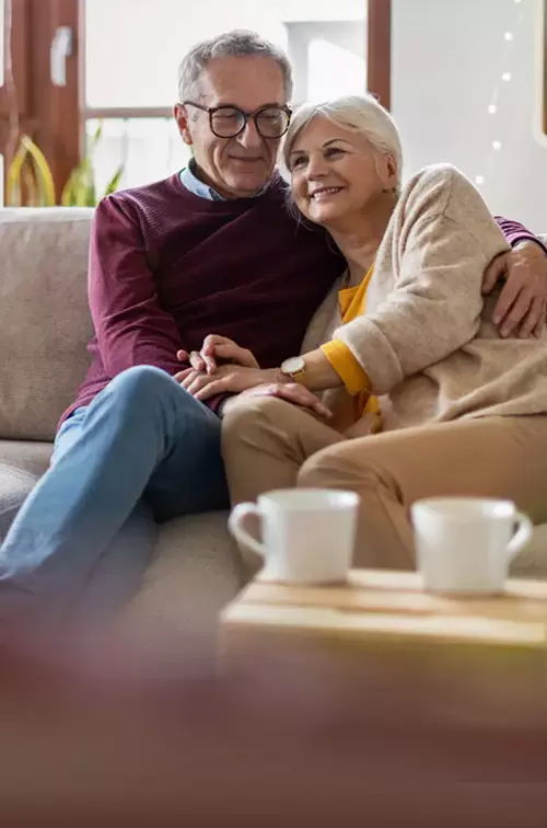 Hero older couple sitting on couch