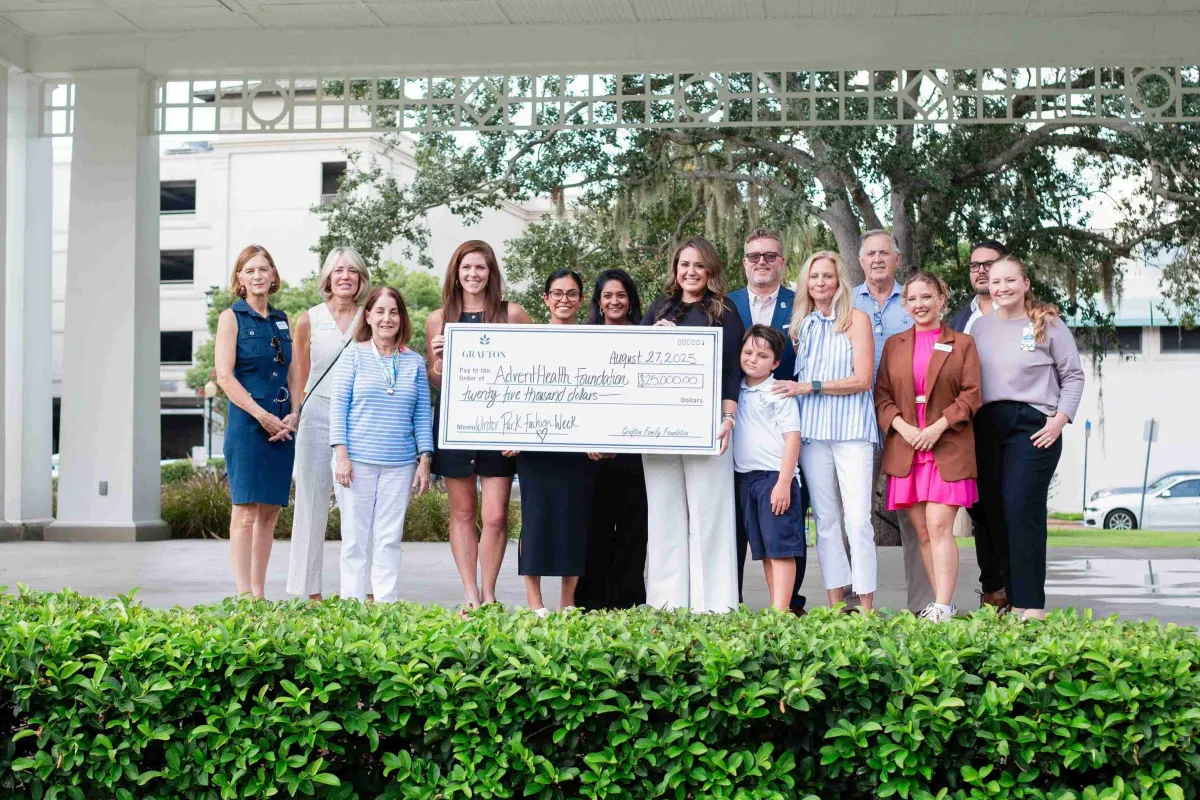Group of people holding large check