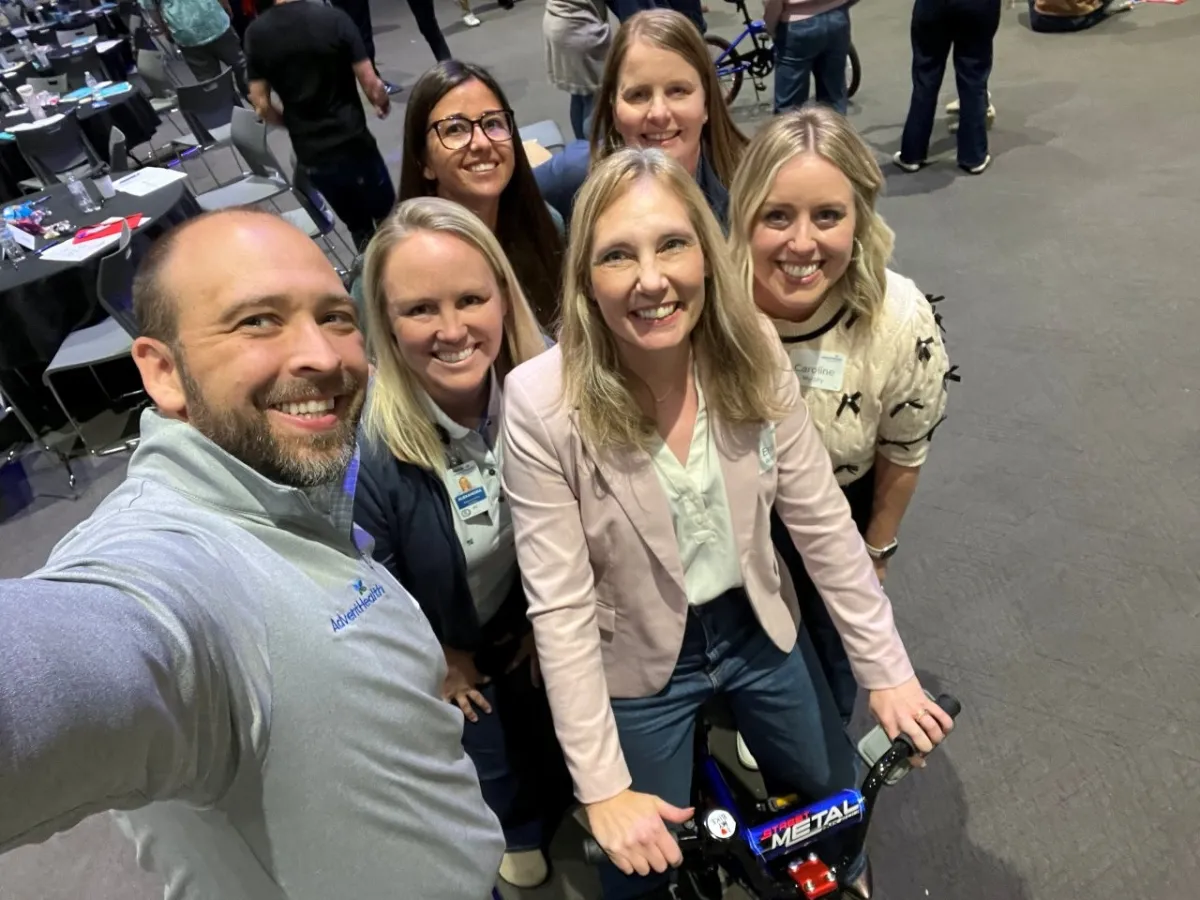 Group of adults with a bike.