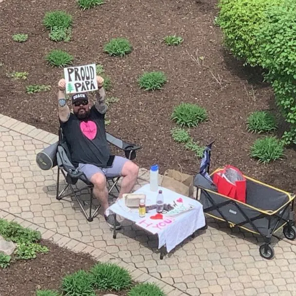 Conlin holding up sign expressing his love