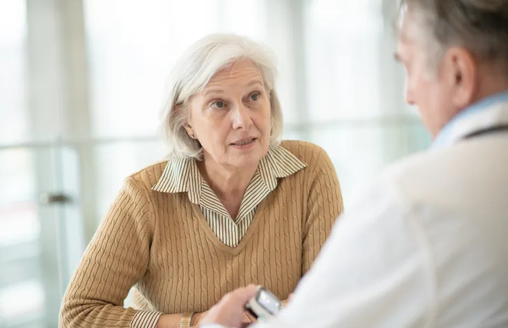 senior woman speaking with doctor