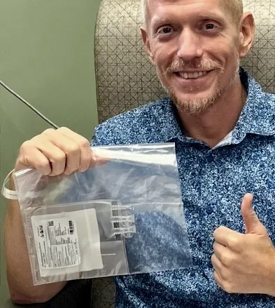 Jeff Bishop holding his supercharged T-cells right before they were infused.