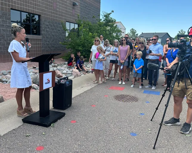 Kara Baker speaks at a ribbon cutting ceremony