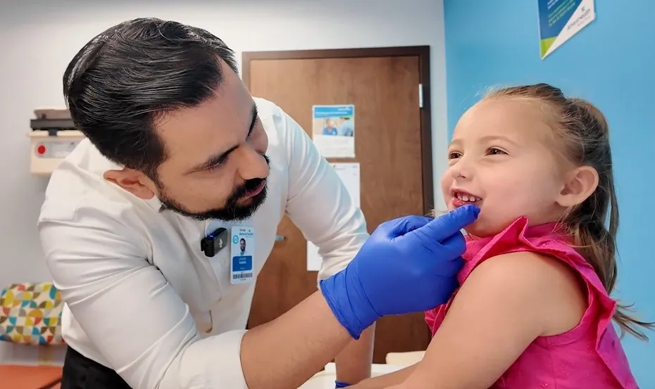 Dr. Joseph Lopez examines the mouth of a little girl named Madi, who had a cancerous tumor in her jaw.
