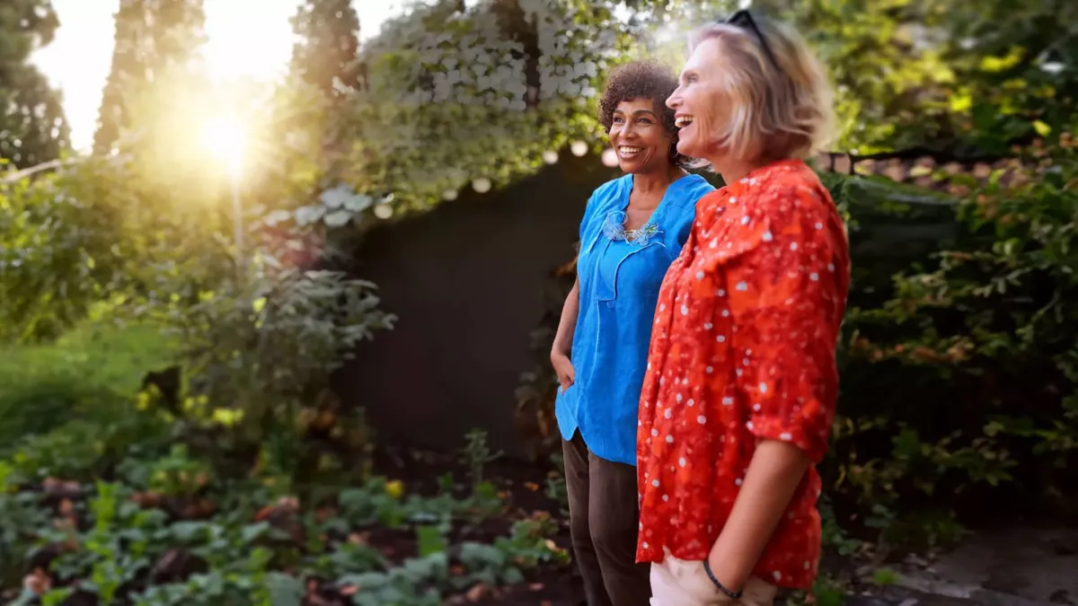 Retirement-aged women standing in garden