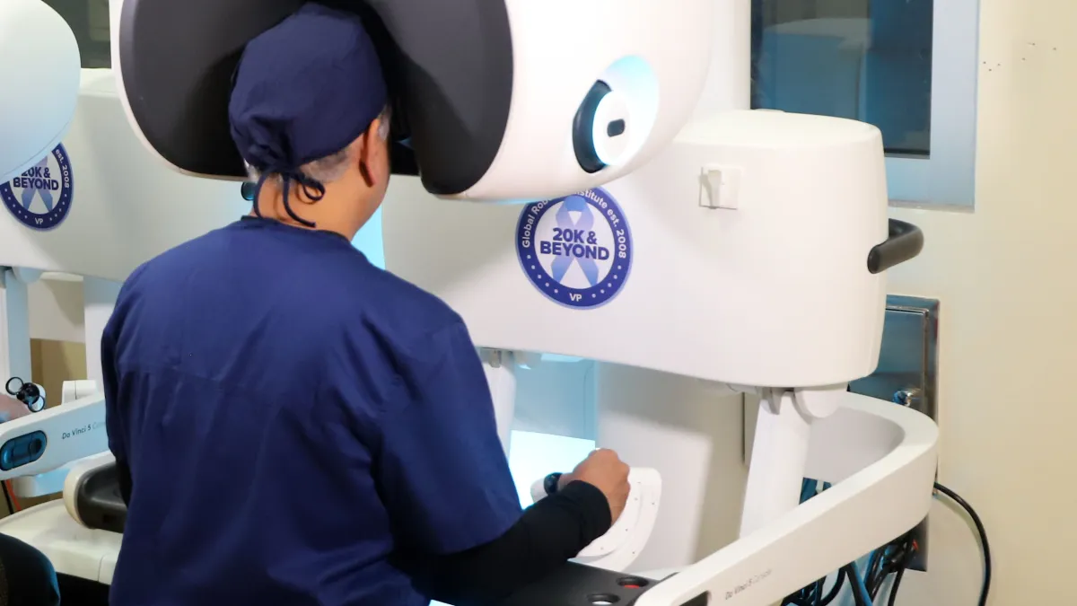 Dr. Vipul Patel sits at a console