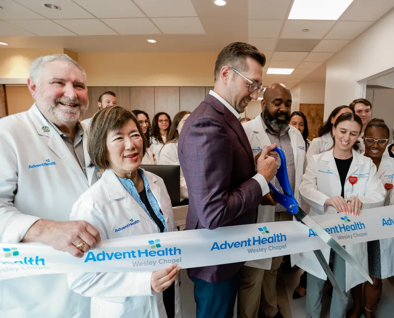 Group of people at the ribbon cutting of Wesley Chapel.