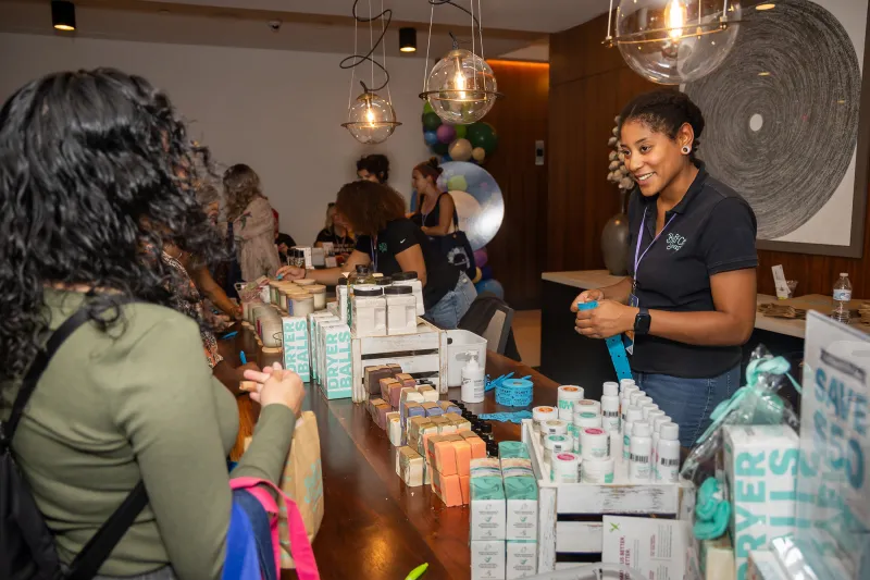 Women attending the Women’s Health and Cancer Prevention Event, visiting a table with products.