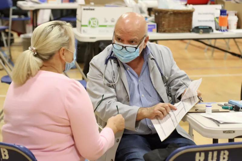 AMITA volunteer talking with Glendale Heights community member.