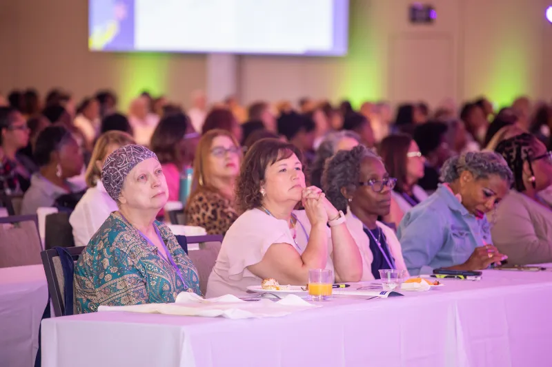 Women attending the Women’s Health and Cancer Prevention Event watching the presentation.