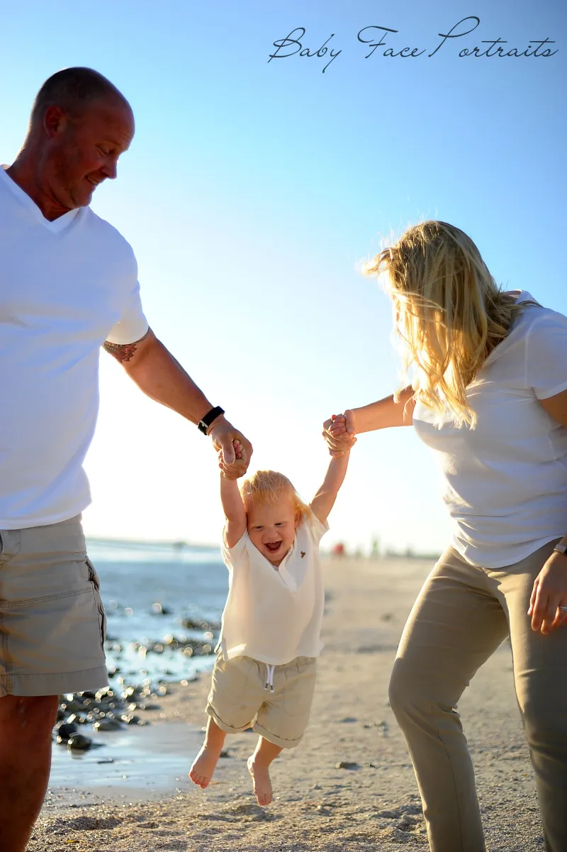 A couple with their child at the beach.