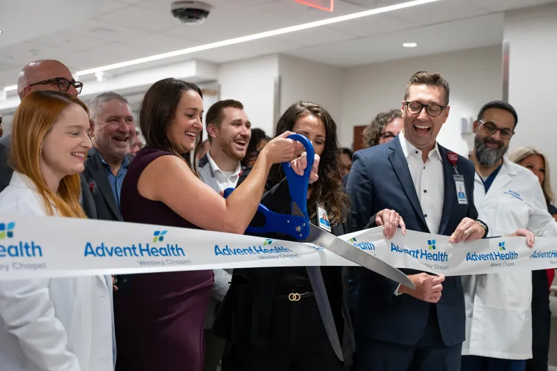 Group of people at the ribbon cutting of Wesley Chapel.