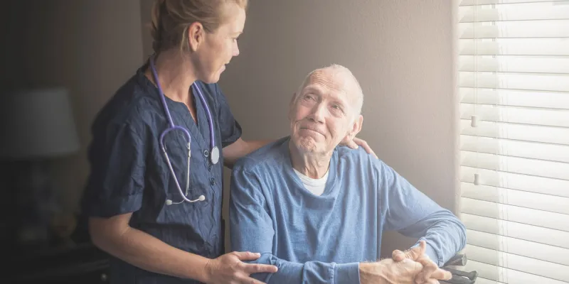 Nurse with a male hospice patient.