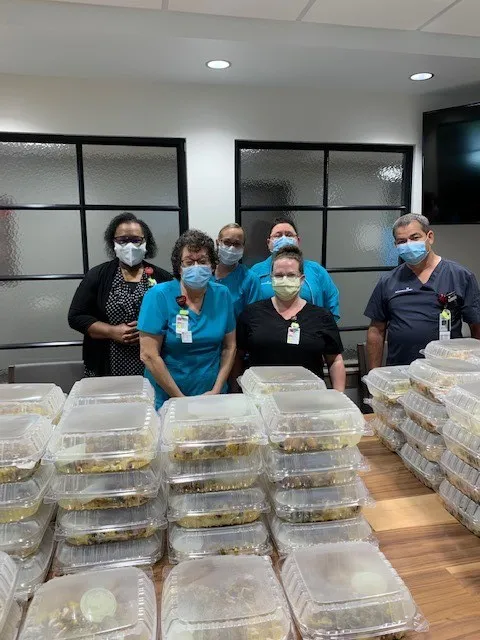 A group of health care workers with food donations
