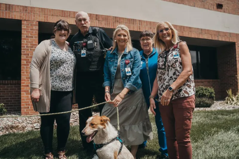 ottawa leadership posing with rescue dog
