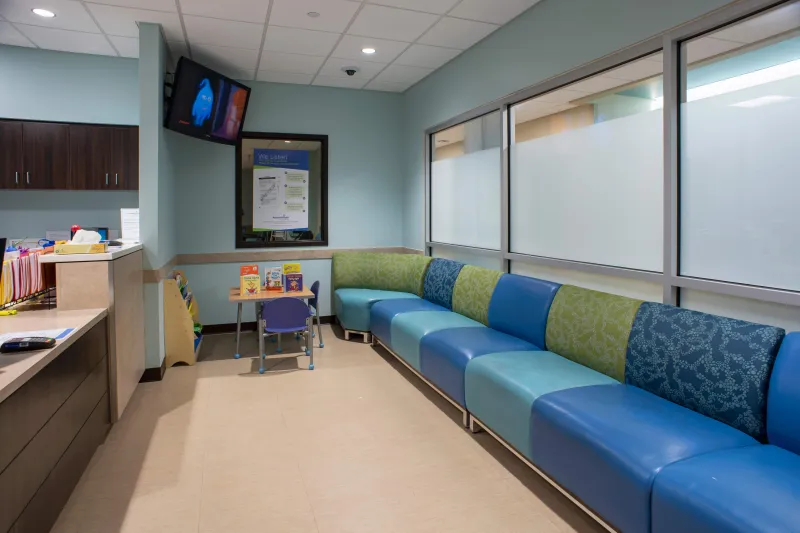 Waiting room with chairs and a desk.